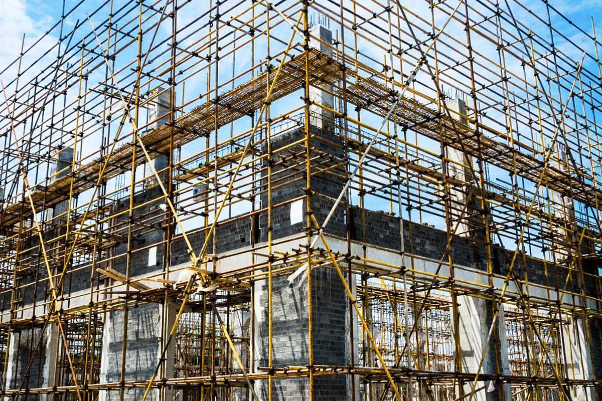Steel scaffolding erected around a multi-storey concrete building under construction